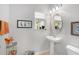 Small bathroom with pedestal sink, toilet, and decorative elements at 207 Maplebrook Dr, Altamonte Springs, FL 32714