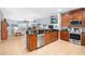 Open kitchen with breakfast bar, stainless steel appliances, and view to living area at 207 Maplebrook Dr, Altamonte Springs, FL 32714