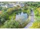 Aerial view of a townhouse community with a pond, highlighting its tranquil environment at 207 Maplebrook Dr, Altamonte Springs, FL 32714