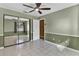 Bedroom with mirrored closet doors and ceiling fan at 2711 Ambrosia Ct, Apopka, FL 32703