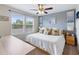 King-size bed, ceiling fan, and windows with blinds in the bedroom at 5128 Caspian St, Saint Cloud, FL 34771