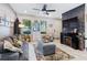 Spacious living room with fireplace, gray sofa, and ceiling fan at 5128 Caspian St, St Cloud, FL 34771