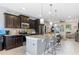 Spacious kitchen featuring dark wood cabinets, granite countertops, and stainless steel appliances at 5128 Caspian St, St Cloud, FL 34771
