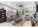 Spacious living room with fireplace, gray sofa, and ceiling fan at 5128 Caspian St, St Cloud, FL 34771