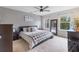 King-size bed, carpeted floor, and large windows in the bedroom at 5128 Caspian St, St Cloud, FL 34771