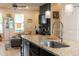 Kitchen island with granite countertop, sink, and stainless steel dishwasher at 5128 Caspian St, Saint Cloud, FL 34771