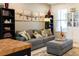 Open concept living room and kitchen with gray sofa and wood-top island at 5128 Caspian St, St Cloud, FL 34771