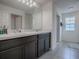 Bathroom with dark vanity, double sinks and marble countertop at 911 Avenal, Davenport, FL 33837