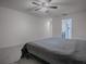 Primary bedroom with grey bedding and ensuite access at 911 Avenal, Davenport, FL 33837