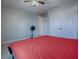 Bedroom with red bedding and ceiling fan at 911 Avenal, Davenport, FL 33837