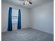 Bright bedroom with blue curtains and carpet flooring at 911 Avenal, Davenport, FL 33837
