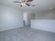 Bedroom with grey carpet, ceiling fan and access to hallway at 911 Avenal, Davenport, FL 33837
