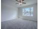 Bright bedroom featuring a large window and ceiling fan at 911 Avenal, Davenport, FL 33837