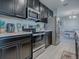 Modern kitchen with stainless steel appliances and dark cabinets at 911 Avenal, Davenport, FL 33837