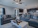 Open concept living room with gray sofas and view into kitchen at 911 Avenal, Davenport, FL 33837