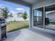 Covered patio with sliding glass doors and grill at 911 Avenal, Davenport, FL 33837