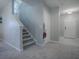 Staircase with gray carpeting, leading to the second floor at 911 Avenal, Davenport, FL 33837