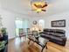 Bright living room with hardwood floors and a ceiling fan at 941 Rimini Dr, St Cloud, FL 34771