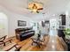 Open concept living room with hardwood floors and kitchen island at 941 Rimini Dr, St Cloud, FL 34771