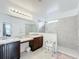 Clean bathroom with double vanity, large shower, and accessible features at 941 Rimini Dr, St Cloud, FL 34771