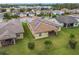 Aerial view of home with solar panels, patio, and lush landscaping at 941 Rimini Dr, St Cloud, FL 34771