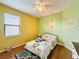 bedroom with yellow and green walls, and twin bed at 941 Rimini Dr, St Cloud, FL 34771