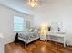 Charming bedroom with a full bed, white dresser, and wood floors at 941 Rimini Dr, St Cloud, FL 34771