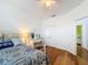 Bedroom with a queen bed, vanity, and wood floors at 941 Rimini Dr, St Cloud, FL 34771