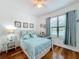 Bedroom with a white metal bed frame and coastal decor at 941 Rimini Dr, St Cloud, FL 34771