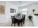 Well-lit dining room with a dark wood table, four chairs, and artwork at 941 Rimini Dr, St Cloud, FL 34771