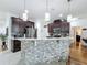 Island kitchen with granite countertops and dark wood cabinets at 941 Rimini Dr, St Cloud, FL 34771