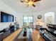 Relaxing living room featuring hardwood floors and ceiling fan at 941 Rimini Dr, St Cloud, FL 34771