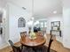 Elegant dining area includes a round table, chairs, and a view into the living room at 941 Rimini Dr, St Cloud, FL 34771