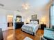 Bright bedroom with wood floors, a queen bed, and ensuite bathroom access at 941 Rimini Dr, St Cloud, FL 34771