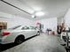 Garage with car, storage, and exercise equipment at 941 Rimini Dr, Saint Cloud, FL 34771