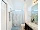 Simple bathroom with shower/tub combo, vanity, and linen storage at 941 Rimini Dr, St Cloud, FL 34771