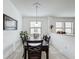 Casual dining area with a dark wood table and four chairs, overlooking the kitchen at 941 Rimini Dr, St Cloud, FL 34771