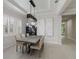 Bright dining room with gray table, chandelier, and white walls at 10159 Royal Island Ct, Orlando, FL 32836