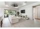 Living room with white couch, sliding doors, and a large TV at 10159 Royal Island Ct, Orlando, FL 32836