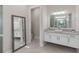 Bathroom with a floating vanity and large mirror at 10159 Royal Island Ct, Orlando, FL 32836