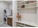 Laundry room with washer, dryer, and built-in shelving at 10159 Royal Island Ct, Orlando, FL 32836