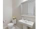 Powder room with pedestal sink and decorative mirror at 10159 Royal Island Ct, Orlando, FL 32836