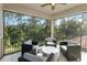 Screened balcony with wooded views and comfortable seating at 10159 Royal Island Ct, Orlando, FL 32836