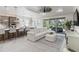 Open concept kitchen and living area with white couches and gray cabinets at 10159 Royal Island Ct, Orlando, FL 32836