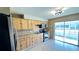 Bright kitchen, stainless steel appliances, wood cabinets, and view to backyard at 105 Lake Villa Way, Kissimmee, FL 34743