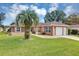 Single story home with palm tree and landscaped lawn at 11447 Sw 69Th Cir, Ocala, FL 34476