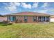 Ranch-style home featuring a large backyard and a well-manicured lawn at 11447 Sw 69Th Cir, Ocala, FL 34476