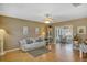Open living space with hardwood floors, a view into sunroom, and comfortable seating at 11447 Sw 69Th Cir, Ocala, FL 34476
