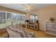 Relaxing sunroom with plenty of windows, comfortable recliner, and built-in shelving at 11447 Sw 69Th Cir, Ocala, FL 34476