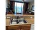 Kitchen sink with view of lake from window at 13415 Blue Heron Beach Dr # 106, Orlando, FL 32821